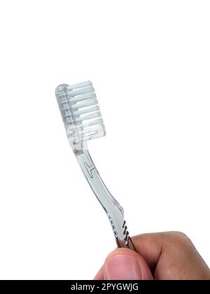 Mano che tiene uno spazzolino da denti. foto su sfondo bianco Foto Stock