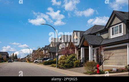 Un quartiere perfetto. Case in periferia a Spring nel Nord America. Vendita Case esterne di fronte in una giornata di sole. Grandi case personalizzate con belle Foto Stock