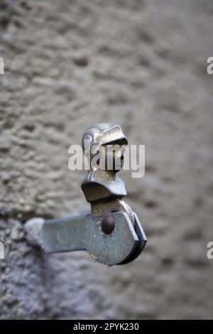 Un supporto in metallo per persiane in legno. Queste sono tenute in posizione durante il giorno e la sera, le persiane chiudono la finestra. Foto Stock