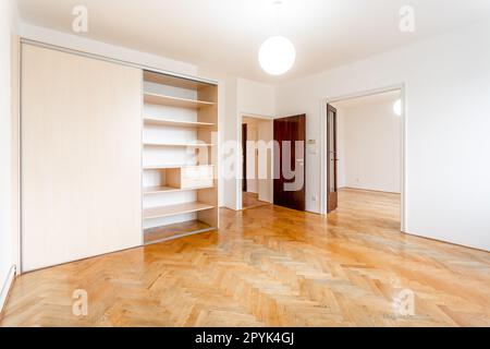 camera vuota in un appartamento con armadio e pavimento in parquet Foto Stock