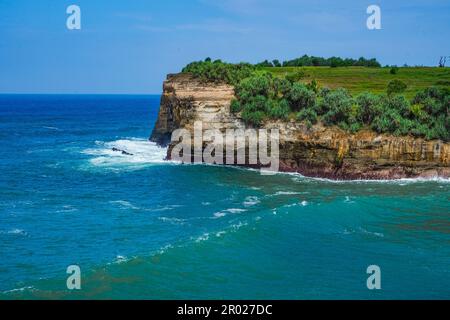 Pantai Klayar o Klayar Beach con rocce e onde forti contro il cielo blu. Sfocatura del movimento. Fotografia di paesaggi. Foto Stock