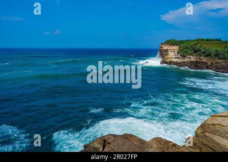 Pantai Klayar o Klayar Beach con rocce e onde forti contro il cielo blu. Sfocatura del movimento. Fotografia di paesaggi. Foto Stock