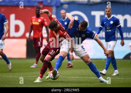 Rostock, Germania. 06th maggio, 2023. Calcio: 2nd Bundesliga, Hansa Rostock - Jahn Regensburg, giorno 31, Ostseestadion. Jan Elvedi (l) di Ratisbona e John Verhoek di Rostock combattono per la palla nel centrocampo. Credit: Gregor Fischer/dpa - NOTA IMPORTANTE: In conformità ai requisiti della DFL Deutsche Fußball Liga e del DFB Deutscher Fußball-Bund, è vietato utilizzare o utilizzare fotografie scattate nello stadio e/o della partita sotto forma di sequenze di immagini e/o serie di foto simili a video./dpa/Alamy Live News Foto Stock