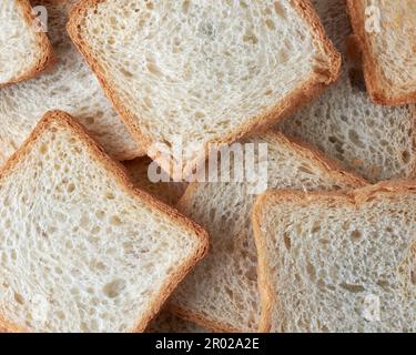 fetta di pane bianco a cornice intera, cibo popolare in molte culture e utilizzato per preparare panini, toast e altri piatti, di colore più chiaro Foto Stock