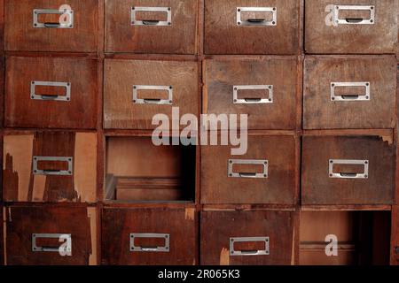 Rotto legno vintage armadio con cassetti mancanti. Scheda libreria o catalogo file. Concetto di database retrospettivo. Foto Stock