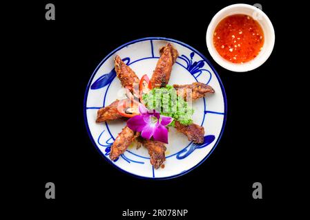 Calamari fritti con verdure su sfondo nero per un menu Foto Stock