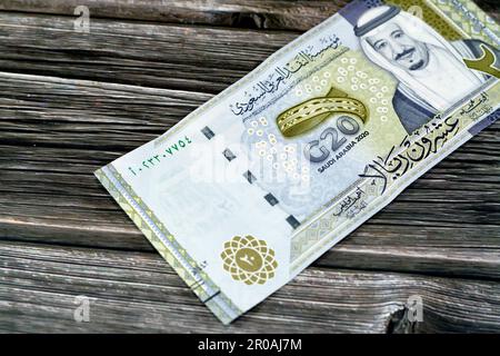 Lato opposto di 20 SAR Twenty Saudi Arabia Riyals banconota moneta conto emissione commemorativa con ritratto di re Salman , 3D logo del Regno Foto Stock