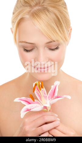 È così dolce. Studio shot di una bella giovane donna in possesso di un giglio tigre. Foto Stock