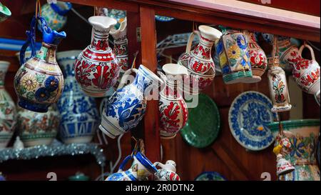 Caraffe in ceramica tradizionali romene decorate con motivi floreali dipinti dal villaggio di Corund in vendita in una fiera di Bucarest Foto Stock