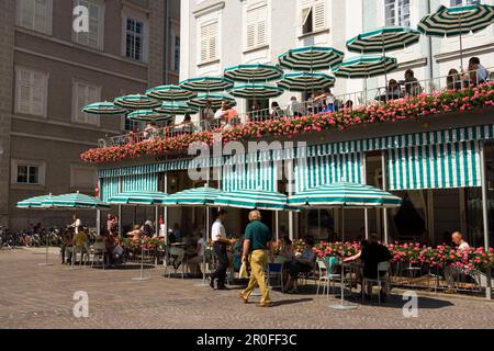 Gli ospiti seduti nell'area esterna del Cafe Tomaselli, il più antico caffè originale di Vienna dell'Austria, fondato nel 1705, Old Market, Salisburgo, Salisburgo, Aus Foto Stock