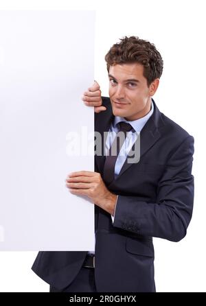 Vuoi vedere questo. Un bel giovane uomo d'affari che sbirciava da dietro copyspace. Foto Stock