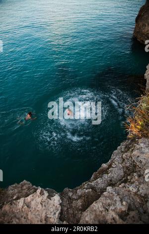 BERMUDA. Parrocchia di Hamilton. Cliff jumping, nuoto fuori da un punto nella Admiralty House Park di Hamilton. Foto Stock