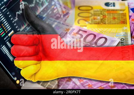 Grafico dell'economia: Pollice in alto con la bandiera della Germania, gli indicatori del mercato azionario e le banconote in euro in contanti (moneta, inflazione, successo, mercati, finanza, aziendale) Foto Stock