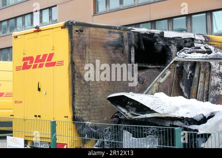 11 maggio 2023, Amburgo: Diversi furgoni di consegna bruciati si trovano nel parcheggio di un centro di distribuzione della posta ad Amburgo-Altona, Germania, che ha preso fuoco giovedì sera. La schiuma antincendio bianca può essere vista dall'operazione antincendio. Tre furgoni erano a fuoco pieno, due dei quali erano veicoli elettrici che il reparto antincendio doveva lasciare bruciare in modo controllato perché le loro batterie erano danneggiate, secondo un portavoce del reparto antincendio di Amburgo. La causa dell'incendio era inizialmente poco chiara. Tuttavia, una portavoce della polizia ha affermato che erano in corso indagini su sospetti Foto Stock