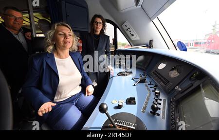 11 maggio 2023, Turingia, Erfurt: Susanna Karawanskij (Die Linke, M), ministro per le infrastrutture e l'agricoltura della Turingia, e Christine Singer (r), presidente della direzione regionale di DB Regio Südost, ispezionano il primo veicolo VT 612 riprogettato con Christoph Jentsch (l), ingegnere veicolo di DB Regio Südost, presso lo stabilimento di DB Regio. DB Regio sta attualmente modernizzando un totale di 36 vagoni ferroviari in tappe, che saranno utilizzati tra Göttingen e Glauchau, Erfurt e Altenburg/Greiz, Erfurt e Würzburg. I veicoli saranno dotati di accessori interni moderni, WLAN, prese USB e una nuova Foto Stock