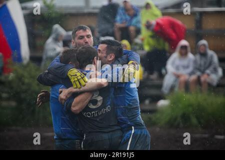 SWAMP SOCCER, FINLANDIA, 2014: I giocatori celebrano il successo della loro squadra. L'annuale Swamp Soccer World Championship 2014 a Ukkohalla a Hyrnsalmi, Finlandia. Fotografia: Rob Watkins. INFO: Swamp Soccer è un fenomeno sportivo bizzarro e fangoso. Giocata su terreni boggy, questo adattamento del calcio aggiunge un tocco di divertimento. I partecipanti si divertono nel caos, trasformando uno sport tradizionale in un'esperienza divertente e memorabile che attira sia giocatori che spettatori. Foto Stock