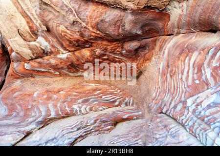 Giordania. Sito archeologico di Petra. Rocce rosse colorate nella grotta Foto Stock