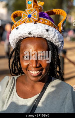 Una giovane donna che indossa Una corona di abiti da fantasia posa per Una foto prima dell'incoronazione di Re Carlo III, The Mall, Londra, Regno Unito. Foto Stock