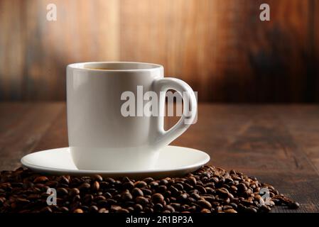 Composizione con tazza bianca e i chicchi di caffè Foto Stock