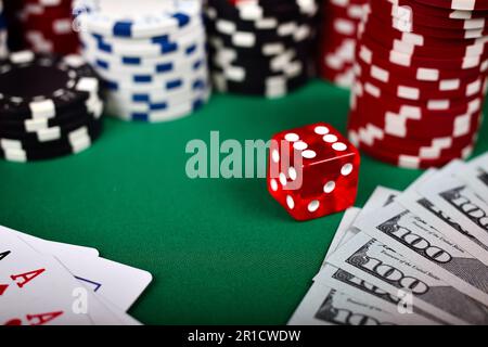 Poker chip, carte, dollaro e dadi sul tavolo verde Foto Stock