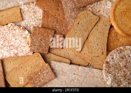 Crocchette di segale fresche, tortine di riso croccanti e fette biscottate come sfondo, giacitura piatta Foto Stock