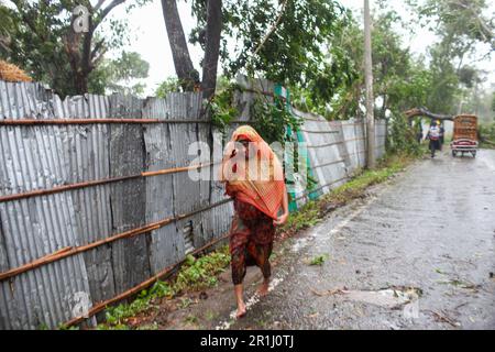 Dhaka, Dhaka, Bangladesh. 14th maggio, 2023. Una donna cammina accanto ad una strada a Teknaf il 14 maggio 2023, durante la caduta del ciclone Mocha. (Credit Image: © Abu Sufian Jewel/ZUMA Press Wire) SOLO PER USO EDITORIALE! Non per USO commerciale! Credit: ZUMA Press, Inc./Alamy Live News Foto Stock