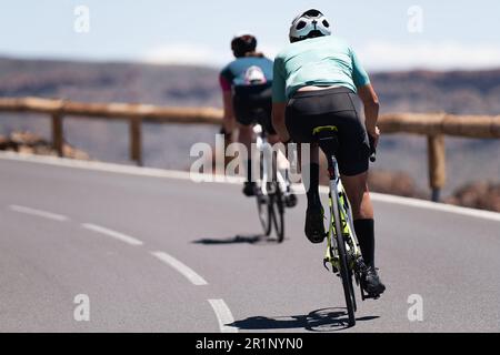 Uomo e donna in bicicletta su strada bici da corsa all'aperto in natura Foto Stock