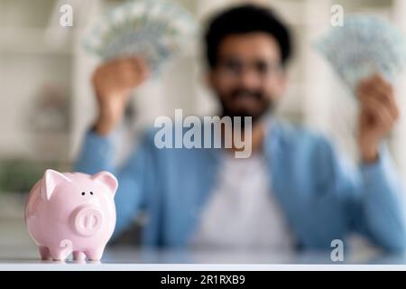 Investimento di successo. Primo piano Shot di Piggy Bank in piedi sul tavolo Foto Stock