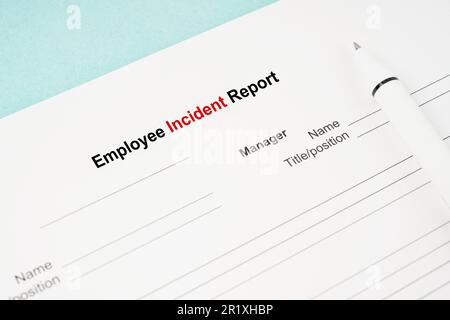 Modello di un documento del modulo di rapporto incidente dipendente e penna su sfondo blu. Foto Stock