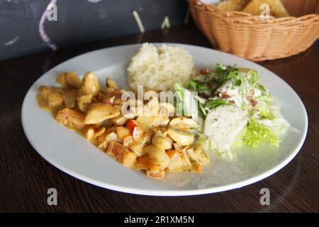 Pollo brasato con verdure e un po' di riso e insalata. Foto Stock