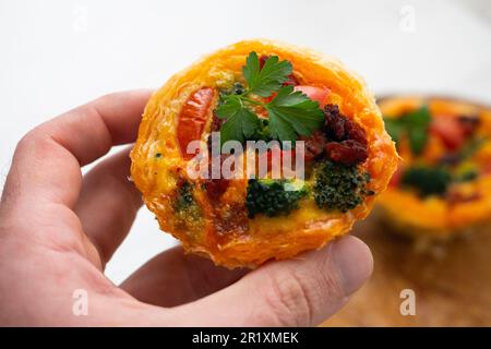 Crostate di pasta sfoglia farcite con broccoli, uova e pomodori ciliegini. Foto Stock