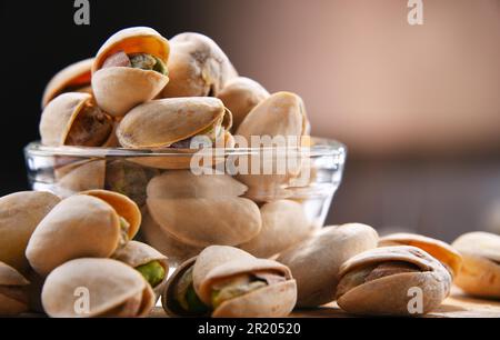 Composizione con ciotola di pistacchi a guscio. Prelibatezze Foto Stock