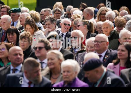 Veterani e altri membri del pubblico durante il servizio nazionale di Remembering - 60 anni dopo, un evento commemorativo della Legione britannica reale per celebrare il servizio e il sacrificio di tutti i veterani del servizio nazionale, al National Memorial Arboretum di Alrewas, Staffordshire. Data immagine: Martedì 16 maggio 2023. Foto Stock