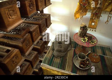 Una scultura, un set di attrezzature balinesi e scatole di legno contenenti vecchi manoscritti balinesi con foglie di palma al museo Gedong Kirtya a Singaraja, Buleleng, Bali, Indonesia. "L'accesso al contenuto dei manoscritti è limitato, a causa delle difficoltà linguistiche e della fragilità del documento", ha scritto un gruppo di scienziati guidati da Made Windu Antara Kesiman del Laboratoire Informatique Image Interaction (L3i), Università di la Rochelle, Durante la 15th Conferenza Internazionale sulle frontiere nel riconoscimento della Scrittura 2016, ottobre 2016, a Shenzhen, Cina. Foto Stock