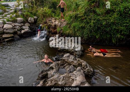 Persone in bagno nel torrente Otumuheke piscine termali, Regione del Lago Taupo, Isola del Nord, Nuova Zelanda. Foto Stock