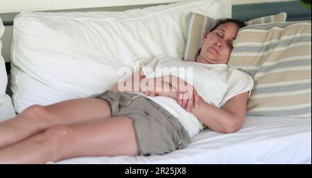 Donna che allettava sul divano balcone nel pomeriggio nap.Person prendendo una pausa riposando e riprendendosi Foto Stock