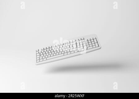 Tastiera bianca per computer che fluttua a mezz'aria con ombre che creano monocromatiche. Concetto di minimalismo, di hardware informatico e di industria del software Foto Stock