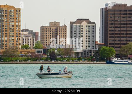 Detroit, Michigan - quattro uomini che pescano da una piccola barca sul fiume Detroit, che forma il confine tra gli Stati Uniti e il Canada. Nel dorso Foto Stock