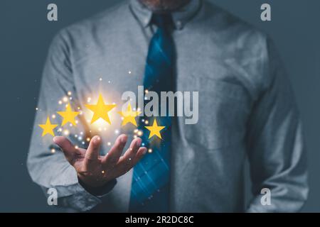 mano del cliente o dell'uomo d'affari che tiene le stelle per completare cinque stelle per la mente di servizio di soddisfazione. sorride ed è felice prima di dare un ratto a cinque stelle Foto Stock