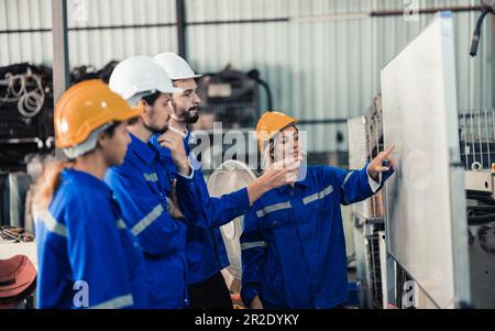 Un gruppo di ingegneri robotici collabora con un brainstorms e discute idee con team interfunzionali su una lavagna per creare strategie e solu Foto Stock