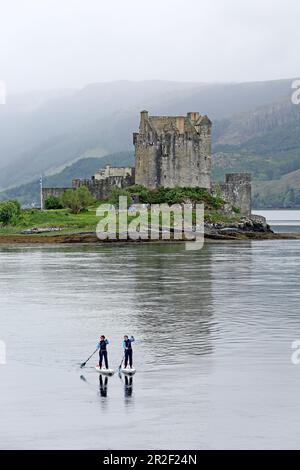 Sali a bordo di paddle al Loch Duich, al castello di Eilean Donan, a Dornie, nelle Highlands Foto Stock