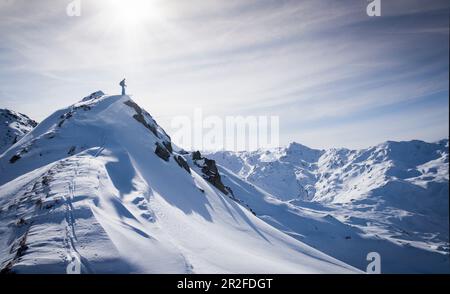 Gli sciatori sul crinale sommitale poco prima della partenza nella neve profonda a Hochfügen Foto Stock