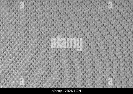 Primo piano dello sfondo del tessuto di lana lavorato a maglia con motivo a punti. Tessuto in lana di colore grigio. Maglia a maglia astratta Openwork. Tessuto astratto indietro Foto Stock