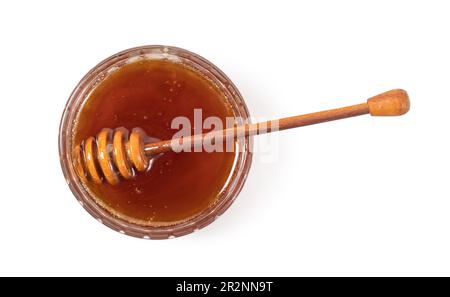 Il miele in un vasetto trasparente con un cucchiaio di miele su sfondo bianco Foto Stock