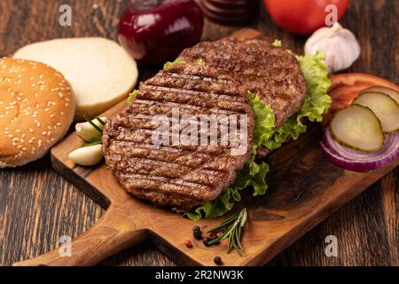 Cotolette di carne fresca su sfondo di legno Foto Stock