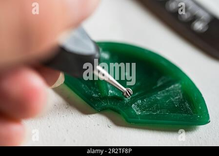 Gioielliere che fa il modello in cera del pendente Foto Stock