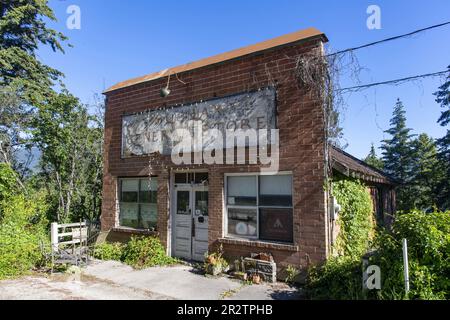 Chase, BC, Canada; 2022 agosto; Vista frontale del verde e disordinato edificio rustico aspetto dello Squilax General Store e Hostel lungo il Foto Stock