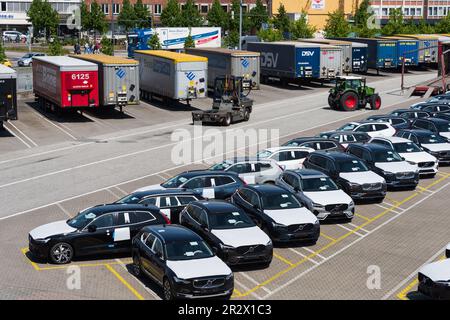 Am Parkplatz des Schwedenkais Warten Neuwagen und LKW-Auflieger auf Verladung auf der Schwedenfähre Foto Stock