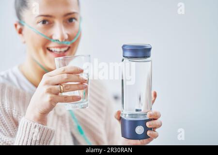 Immagine di una donna che ha acqua idrogeno in mano Foto Stock