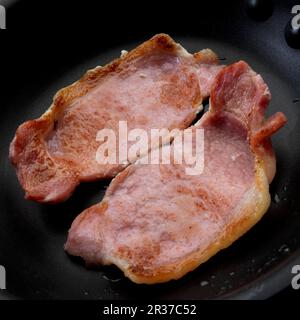 Pancetta inglese fritta in padella Foto Stock